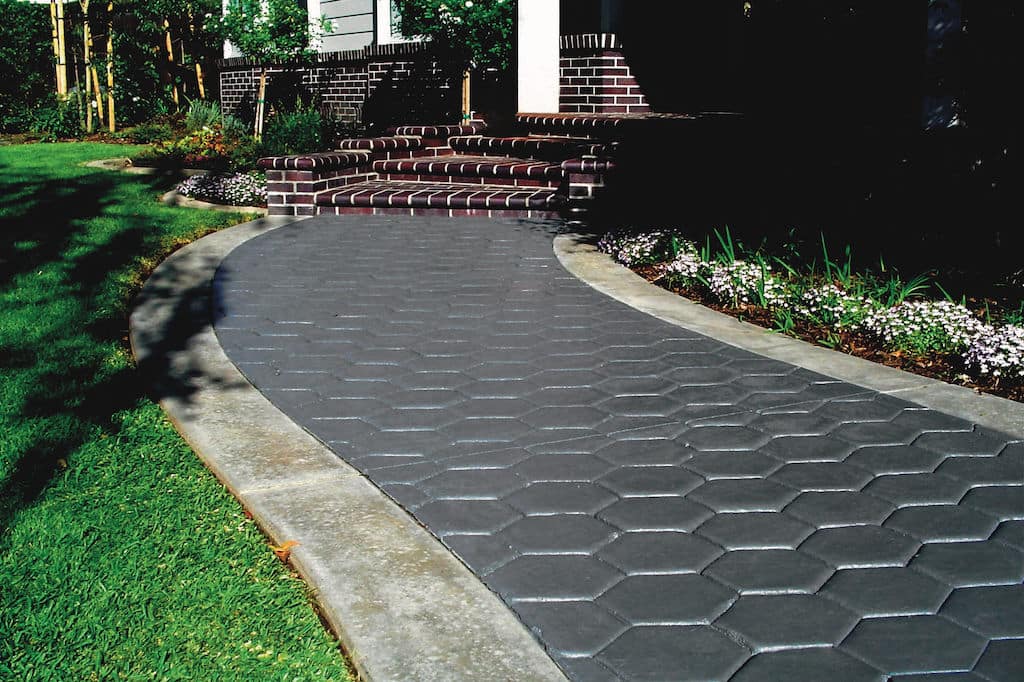 Hexagonal stamped concrete leading to a decorative stairway to your Central Coast home