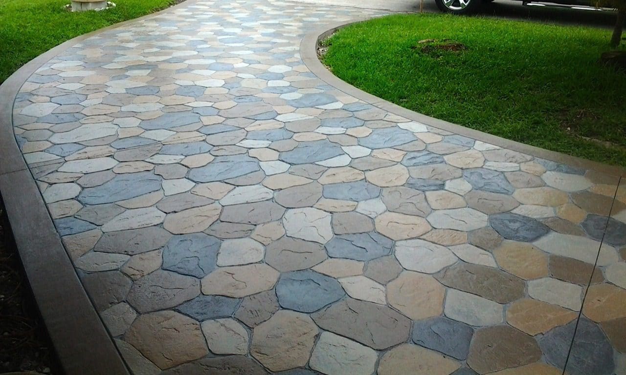 A colorful stamped concrete pathway connecting your garage to your home in Central Coast