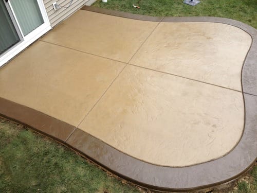 earth-toned coloured concrete installed as the front door paving 
