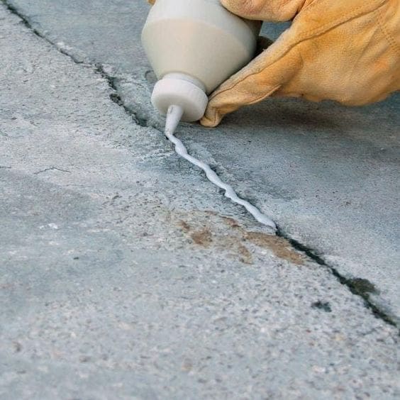 concreters sealing up cracks as part of the concrete resurfacing in Central Coast
