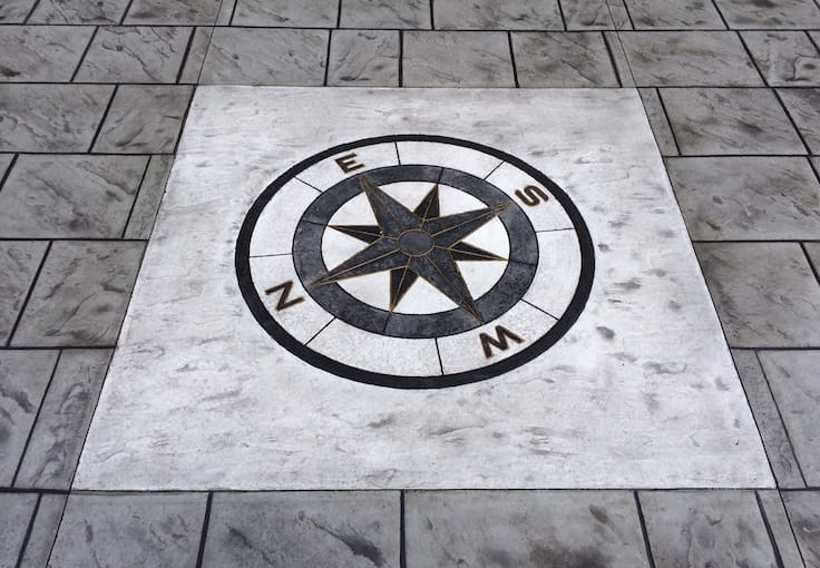 A stamped compass decorative concrete amides the slab makes it stand out in central coast