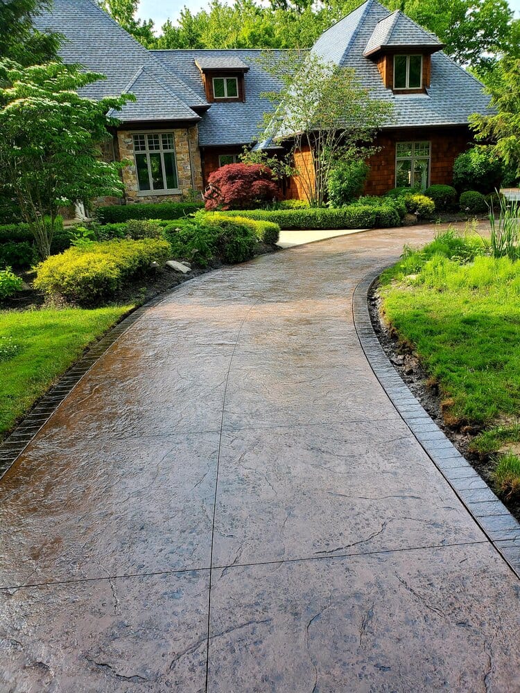 Long coloured concrete driveways in central coast complements the home for a more inviting ambiance.